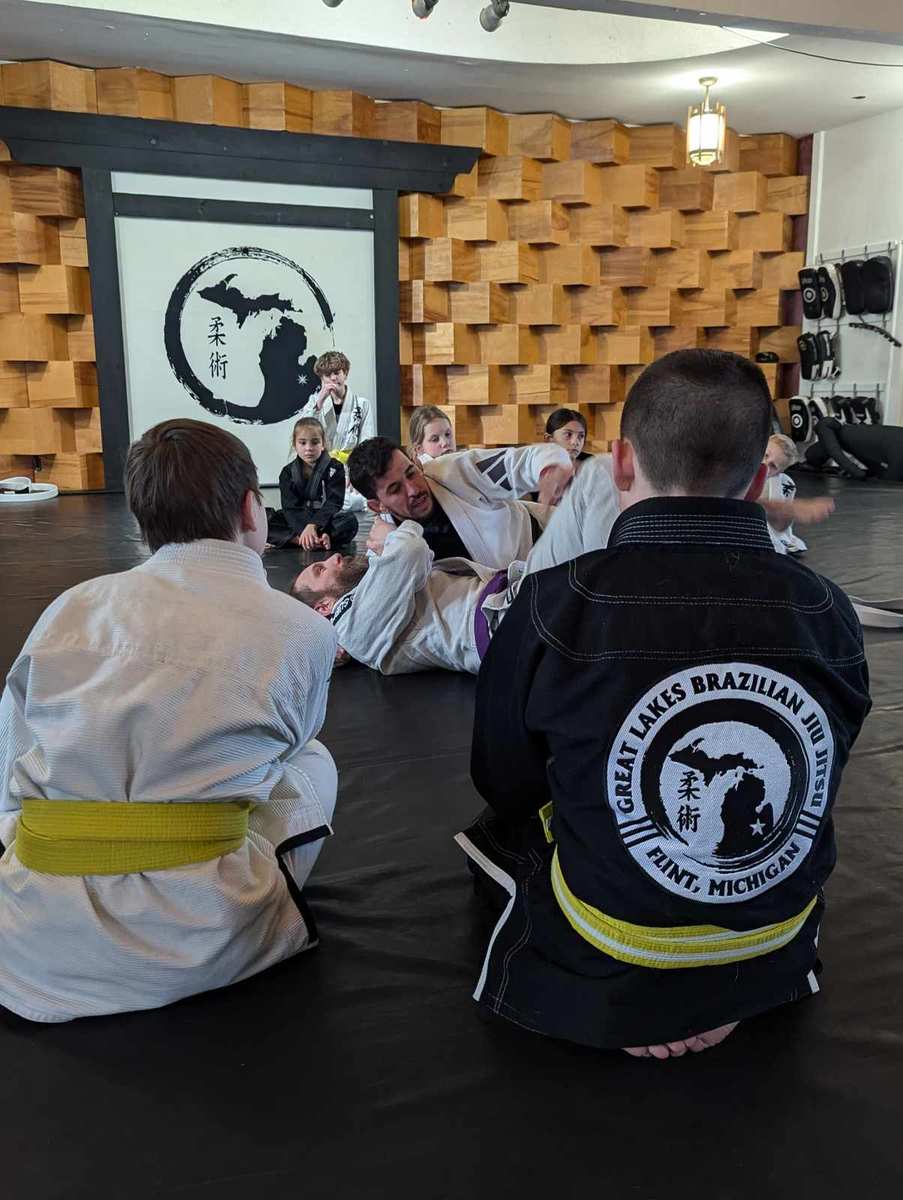 Students watching a jiu jitsu demonstration at Great Lakes BJJ in Flint